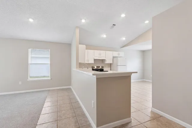 a living room with kitchen island furniture and a window