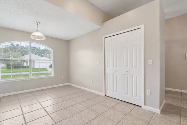 an empty room with windows and outdoor view