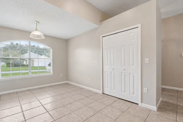 an empty room with windows and outdoor view