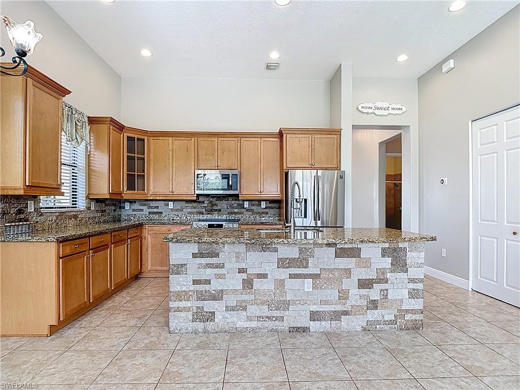 5118 Genoa Street Ave Maria, FL 34142 - Photo 11 of 28 a bathroom with a sink and a large mirror