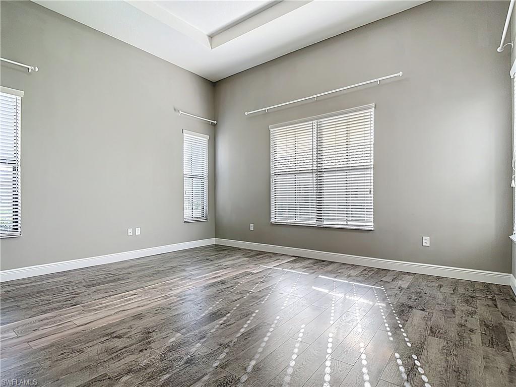 5118 Genoa Street Ave Maria, FL 34142 - Photo 17 of 28 wooden floor in an empty room with a window