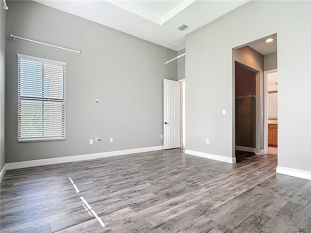 5118 Genoa Street Ave Maria, FL 34142 - Photo 18 of 28 a view of an empty room with window and wooden floor