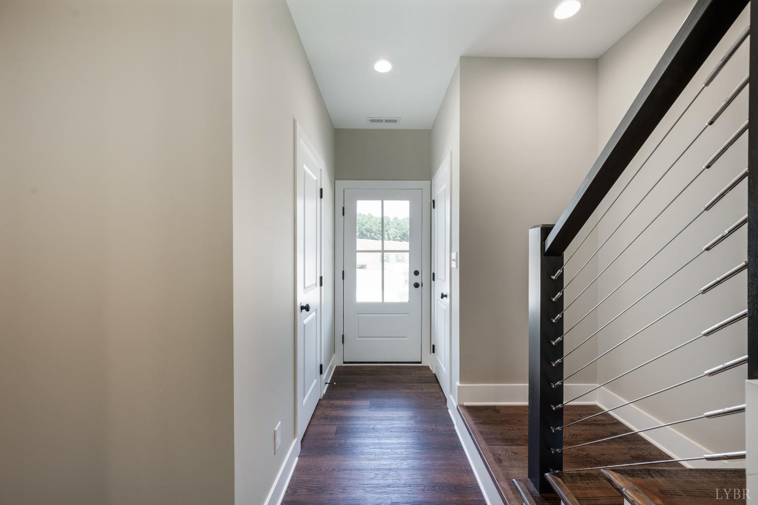 83 Luke Court Rustburg, VA 24588 - Photo 6 of 38 a view of a hallway with wooden floor and staircase