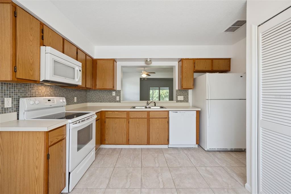 498 Green Spring Circle Winter Springs, FL 32708 - Photo 7 of 20 a kitchen with a refrigerator sink and microwave