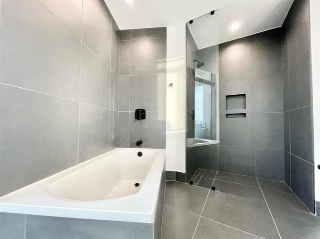 a bathroom with a bathtub and a shower