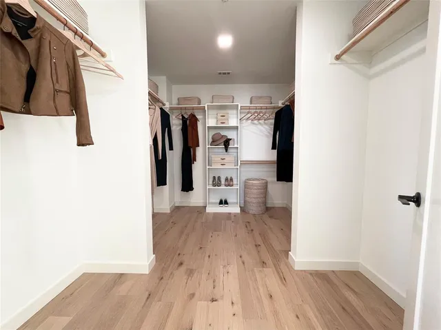 a view of a kitchen with wooden floor and a refrigerator