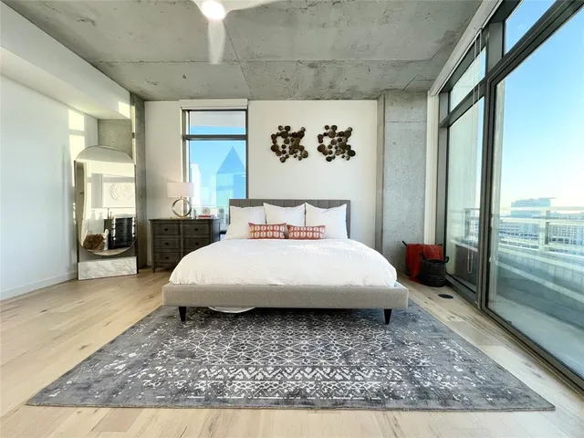 a bedroom with a large bed and a large window