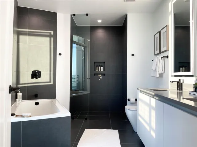 a bathroom with a double vanity sink a mirror and shower
