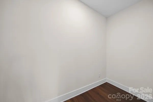 a bedroom with a large bed and a flat tv screen on a dresser