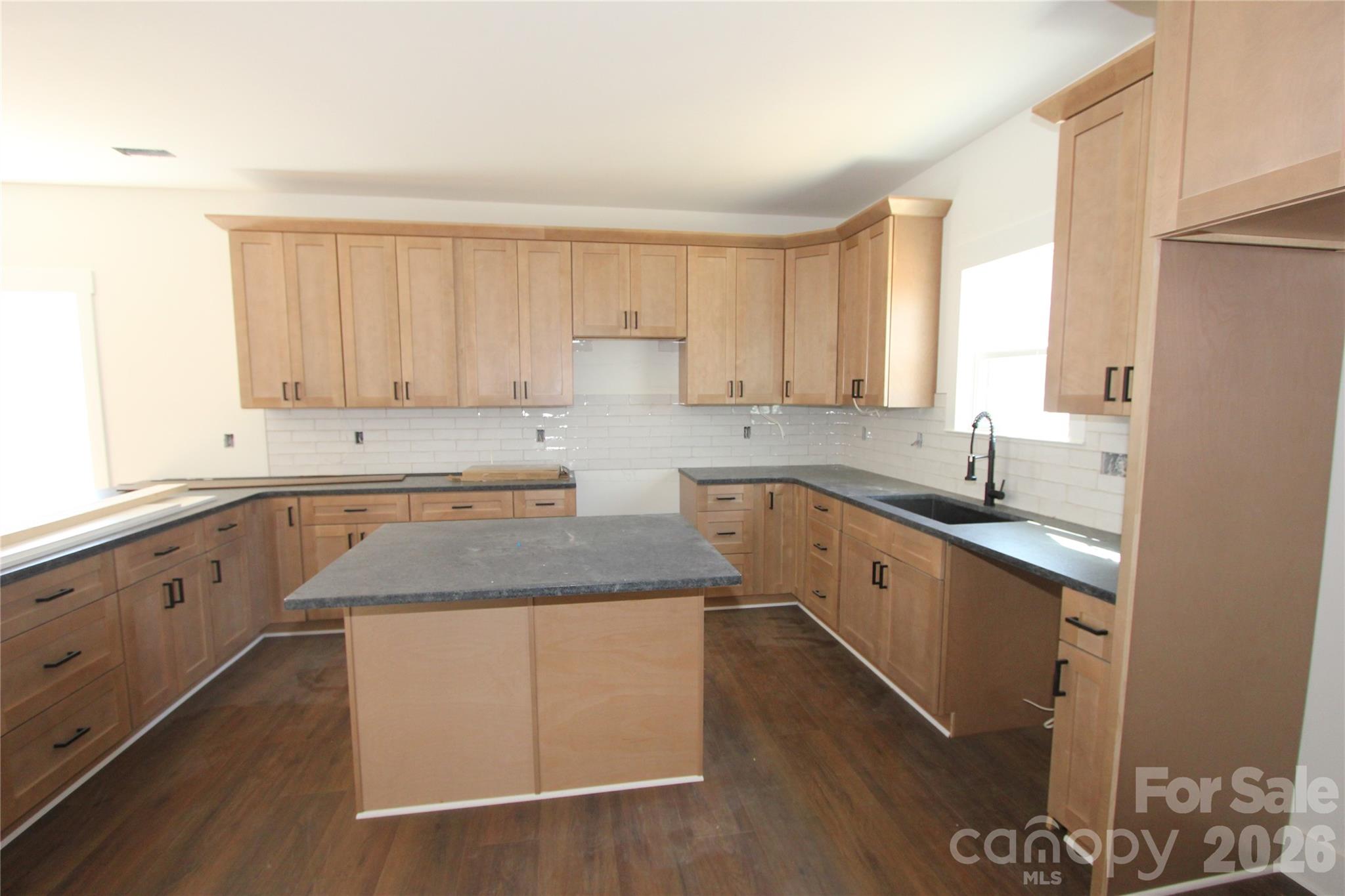 155 Rudisill Road Lincolnton, NC 28092 - Photo 3 of 15 a kitchen with granite countertop white cabinets white appliances a sink and a window