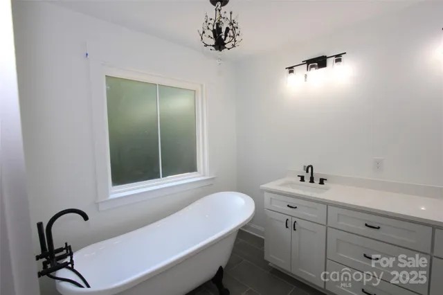 a kitchen with granite countertop a stove sink and cabinets