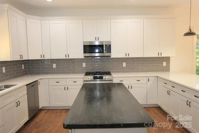 a view of a electric appliances in kitchen and a window