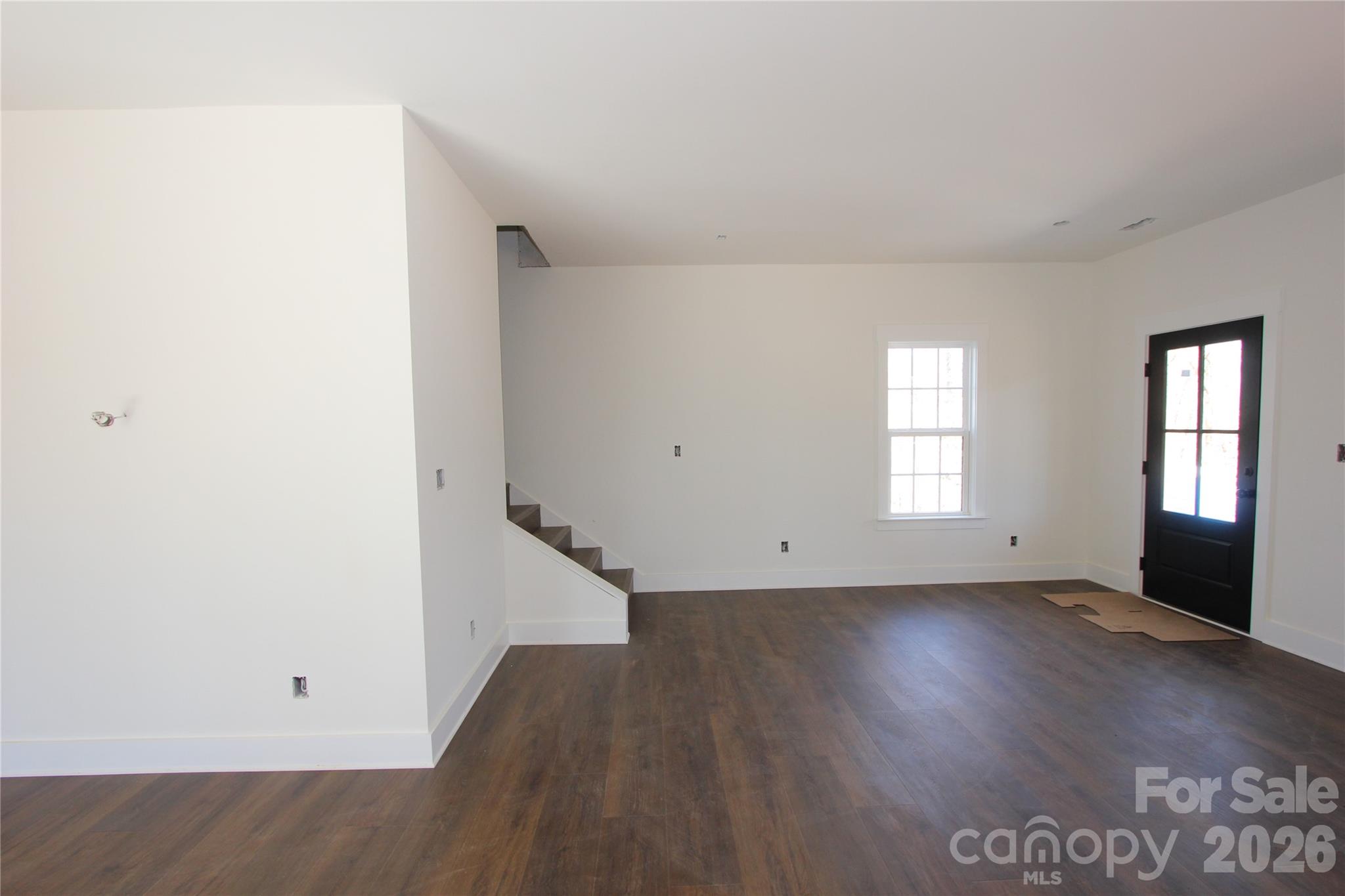 155 Rudisill Road Lincolnton, NC 28092 - Photo 7 of 15 an empty room with wooden floor and windows