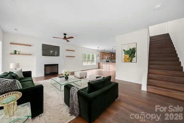 a view of empty room with wooden floor and window