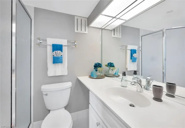a bathroom with a sink toilet and mirror