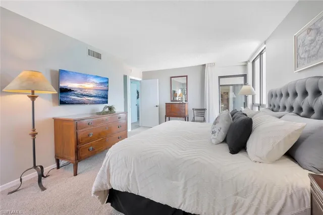 a bedroom with a bed and lamp