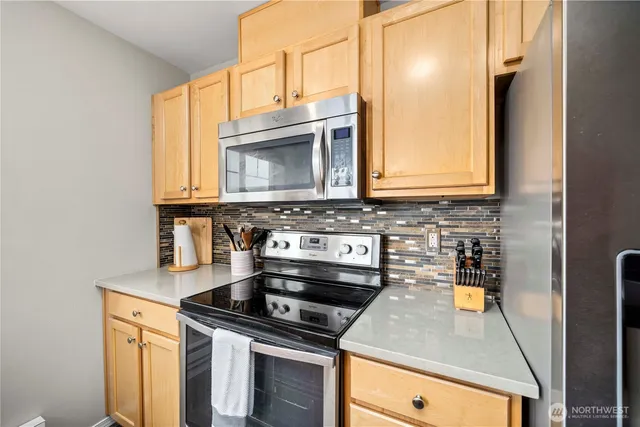 a kitchen with granite countertop a stove and a microwave