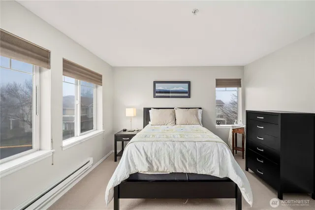 a bedroom with a bed and a large window