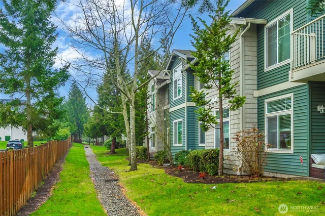 a view of a house with a yard and plants