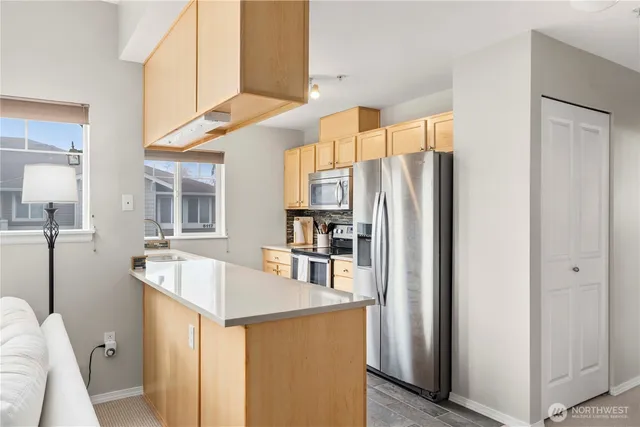 a kitchen with stainless steel appliances a refrigerator and a sink