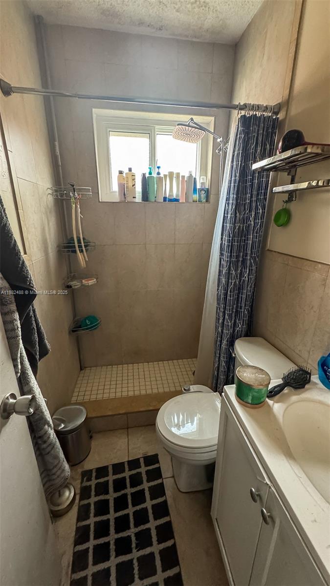 683 Southeast 6th Place Hialeah, FL 33010 - Photo 12 of 18 a bathroom with a toilet a sink and a shower