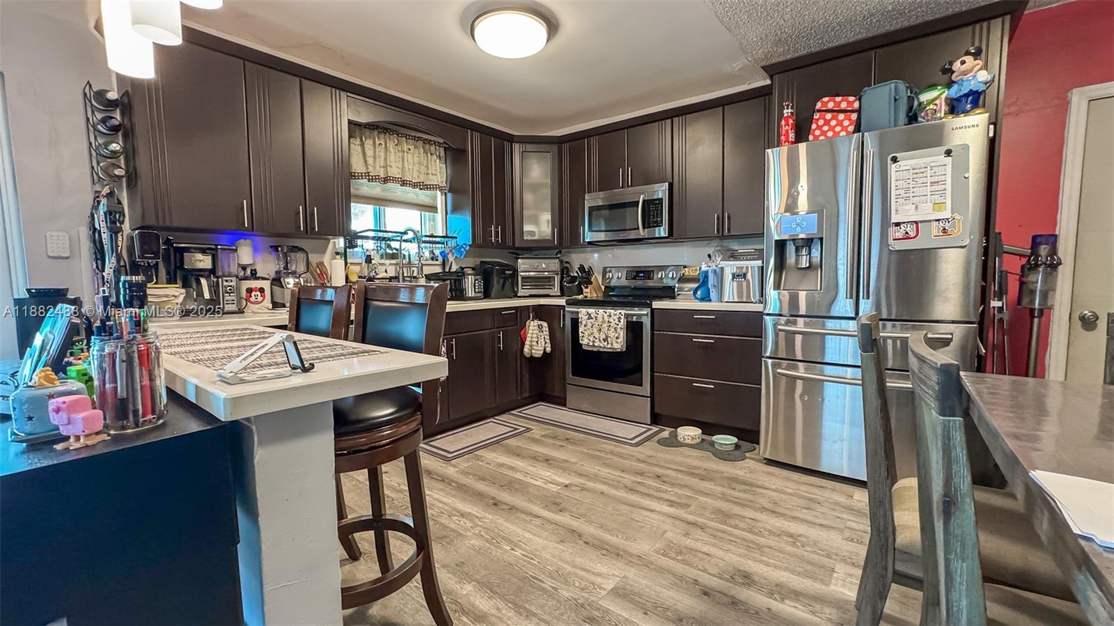683 Southeast 6th Place Hialeah, FL 33010 - Photo 16 of 18 a kitchen with granite countertop a sink appliances and cabinets