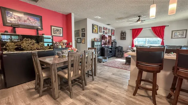 a view of a dining room with furniture a rug and wooden floor