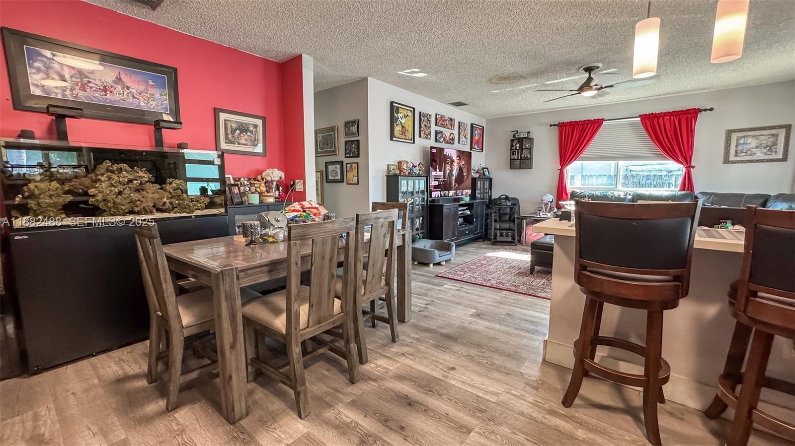 683 Southeast 6th Place Hialeah, FL 33010 - Photo 3 of 18 a view of a dining room with furniture a rug and wooden floor