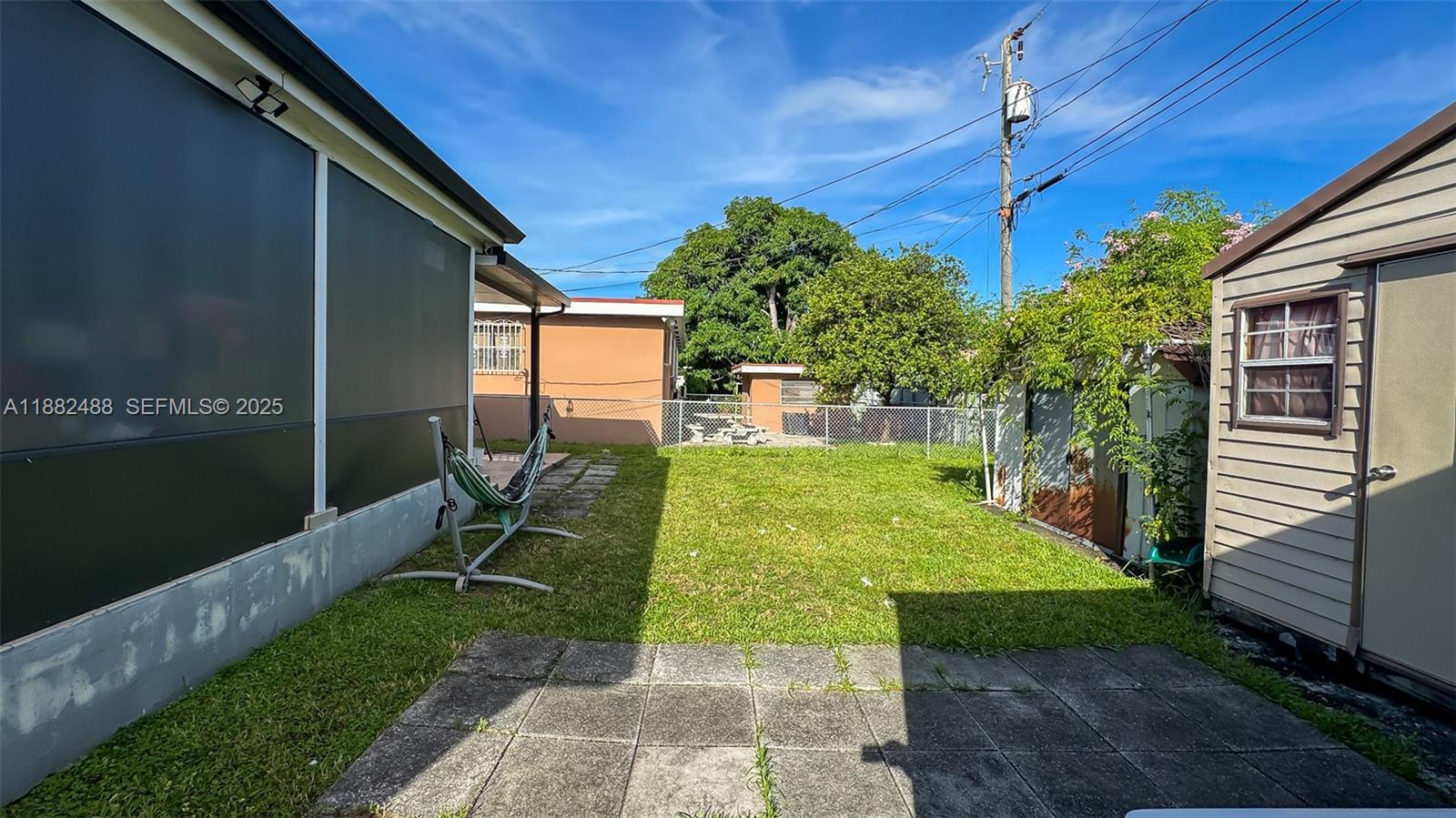 683 Southeast 6th Place Hialeah, FL 33010 - Photo 5 of 18 a view of a patio with table and chairs potted plants with wooden fence