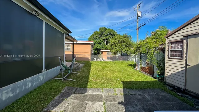 a view of a patio with table and chairs potted plants with wooden fence