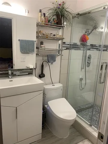 a bathroom with a sink toilet and shower