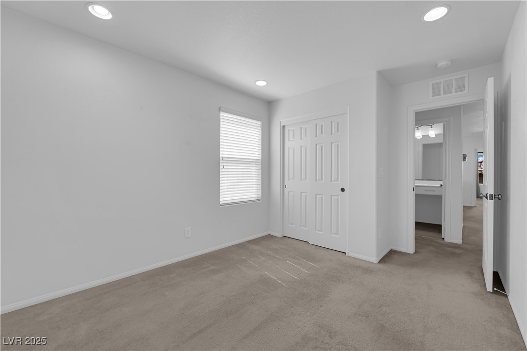 9205 Keystone Ridge Avenue Las Vegas, NV 89148 - Photo 20 of 40 Unfurnished bedroom with carpet flooring, a closet, and recessed lighting