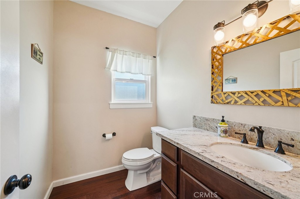 26845 Modoc Lane Lake Arrowhead, CA 92352 - Photo 22 of 56 a bathroom with a granite countertop toilet sink and mirror