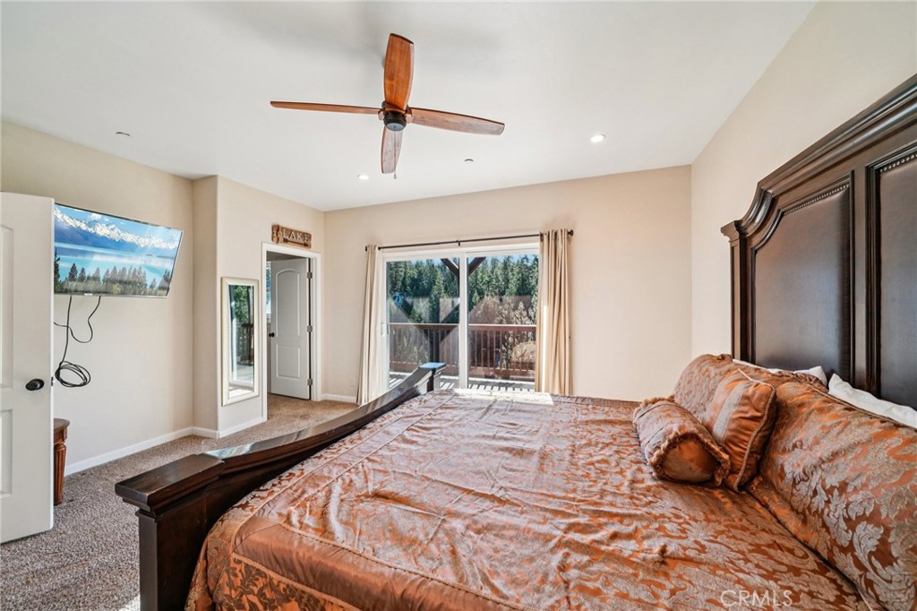26845 Modoc Lane Lake Arrowhead, CA 92352 - Photo 29 of 56 a bedroom with a bed large window and a flat screen tv