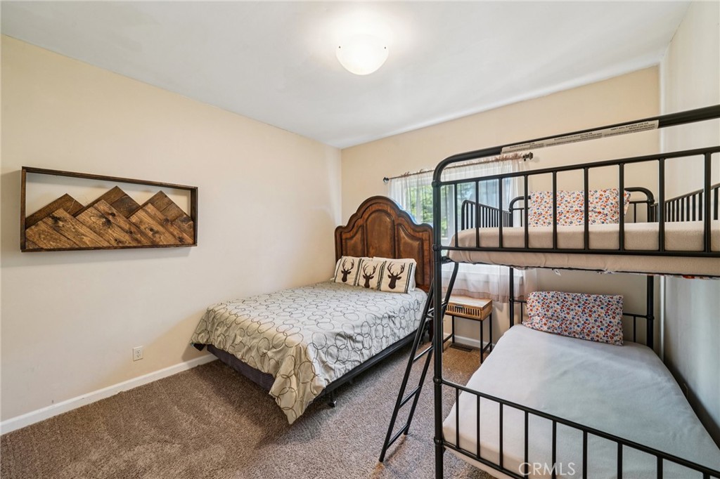 26845 Modoc Lane Lake Arrowhead, CA 92352 - Photo 36 of 56 a bedroom with a bed a couch and a window