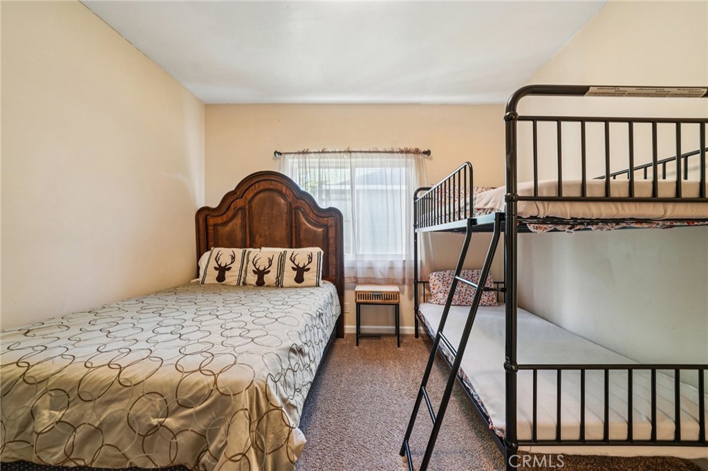 26845 Modoc Lane Lake Arrowhead, CA 92352 - Photo 37 of 56 a bedroom with a bed and wooden floor