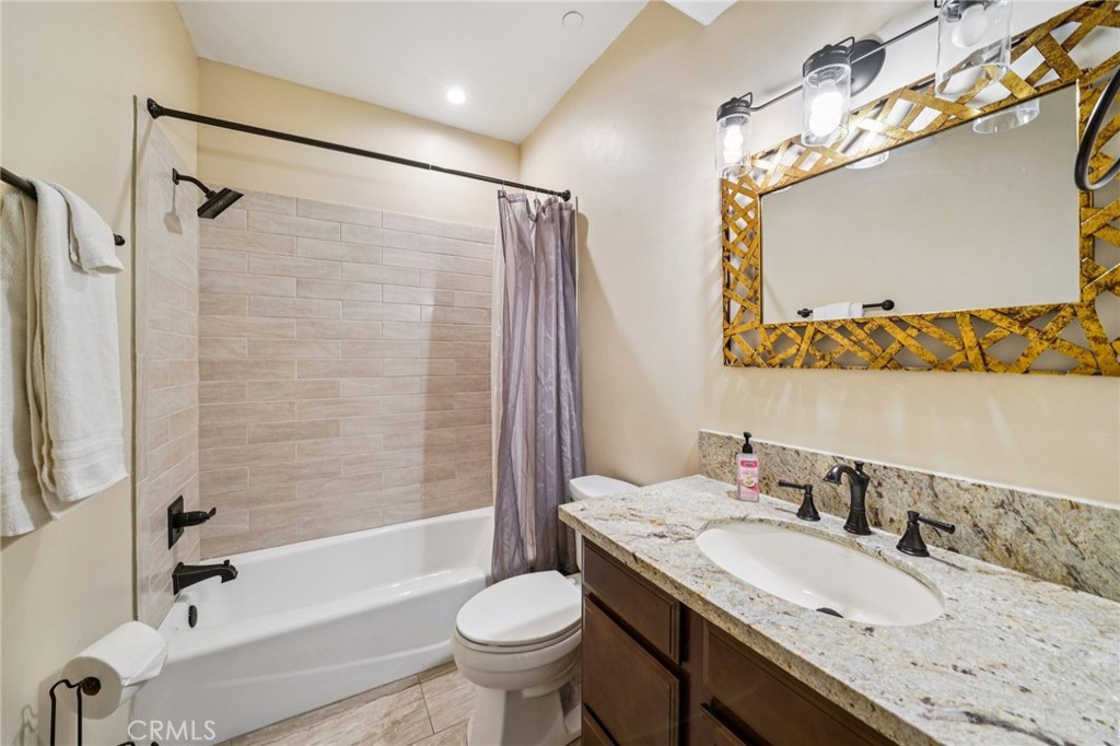 26845 Modoc Lane Lake Arrowhead, CA 92352 - Photo 38 of 56 a bathroom with a granite countertop sink toilet and shower