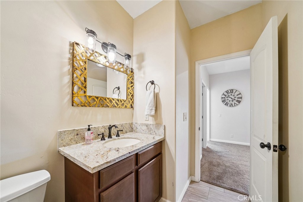 26845 Modoc Lane Lake Arrowhead, CA 92352 - Photo 39 of 56 a bathroom with a granite countertop sink and a mirror