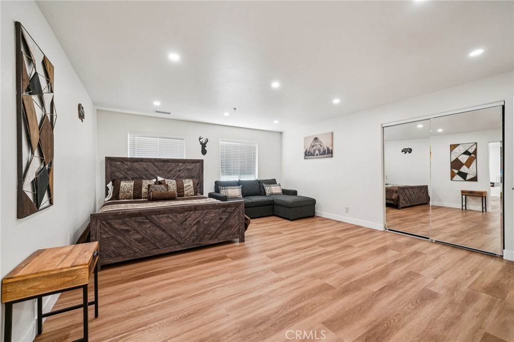 26845 Modoc Lane Lake Arrowhead, CA 92352 - Photo 41 of 56 a spacious bedroom with a bed and a chair