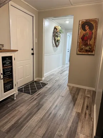 a view of a hallway with wooden floor