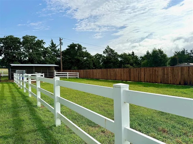 a view of a field with sitting area