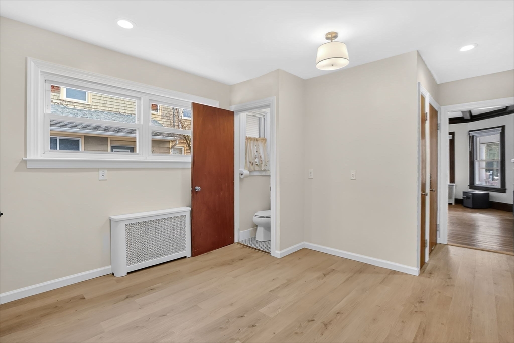 264 Sumner Avenue Springfield, MA 01108 - Photo 11 of 32 an empty room with wooden floor and cabinet