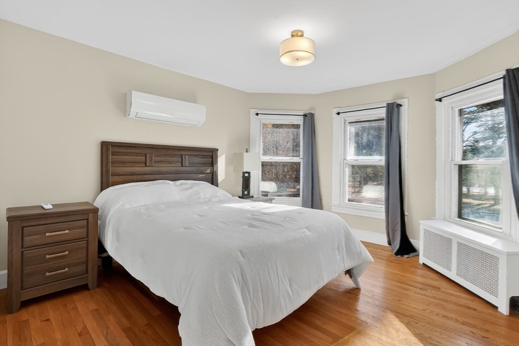 264 Sumner Avenue Springfield, MA 01108 - Photo 12 of 32 a bedroom with a bed and wooden floor