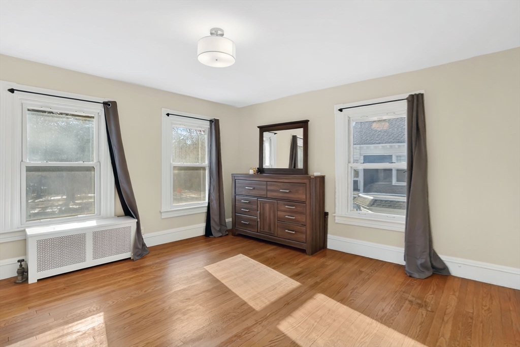 264 Sumner Avenue Springfield, MA 01108 - Photo 14 of 32 a view of a bedroom with wooden floor and cabinet