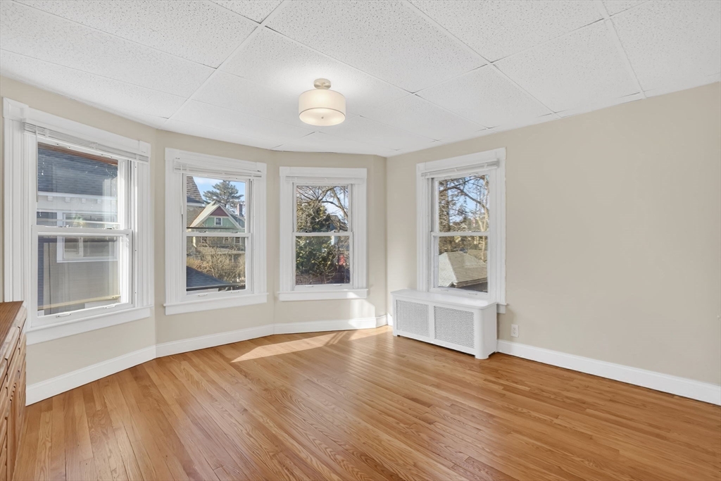 264 Sumner Avenue Springfield, MA 01108 - Photo 17 of 32 a view of an empty room with wooden floor and a window