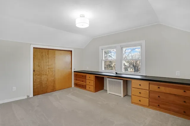 a room with white cabinets and wooden floors