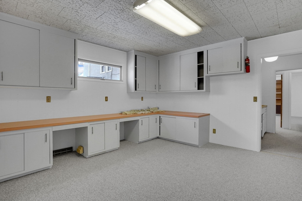 264 Sumner Avenue Springfield, MA 01108 - Photo 28 of 32 a room with white cabinets and wooden floors