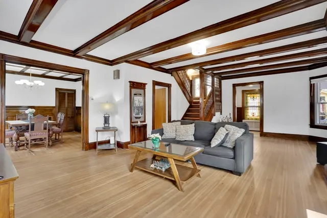 an empty room with wooden floor and cabinet