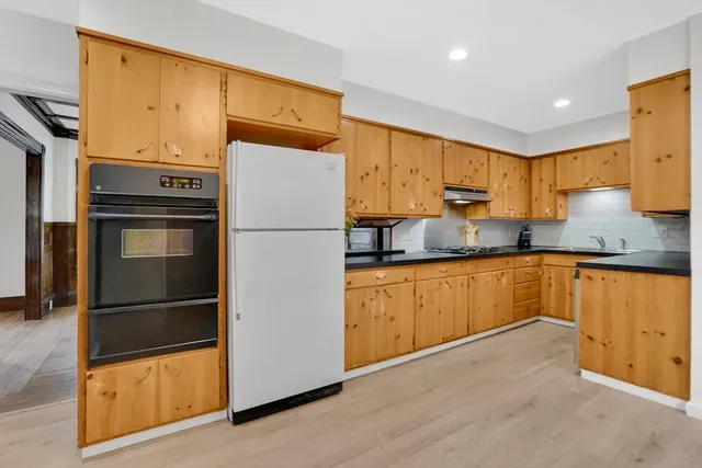 a view of a bedroom with wooden floor and cabinet