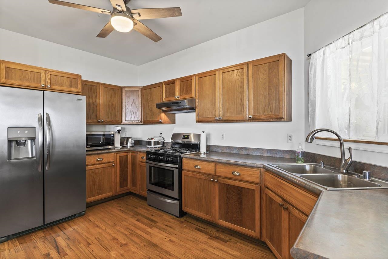 88 Kamalii Place Haiku, HI 96708 - Photo 7 of 24 a kitchen with stainless steel appliances granite countertop a sink a stove a refrigerator with island and cabinets